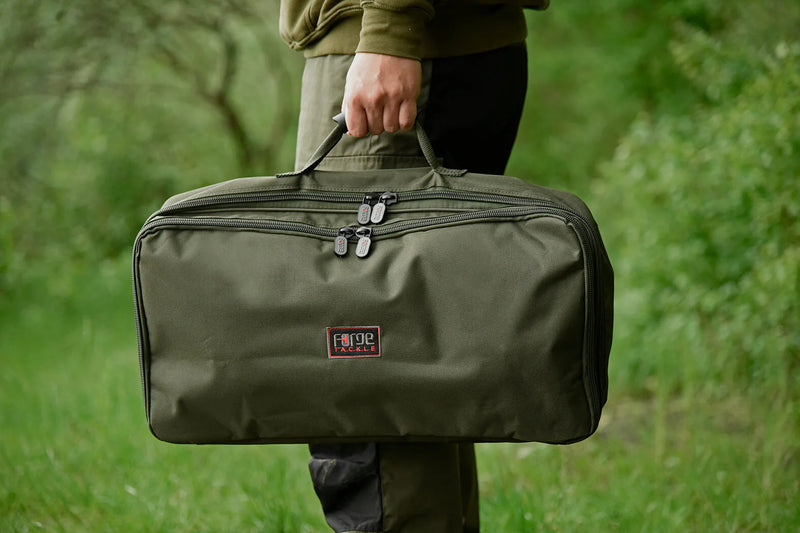 Load image into Gallery viewer, Man holding folded up Z2 Compact Rod Pod in storage bag
